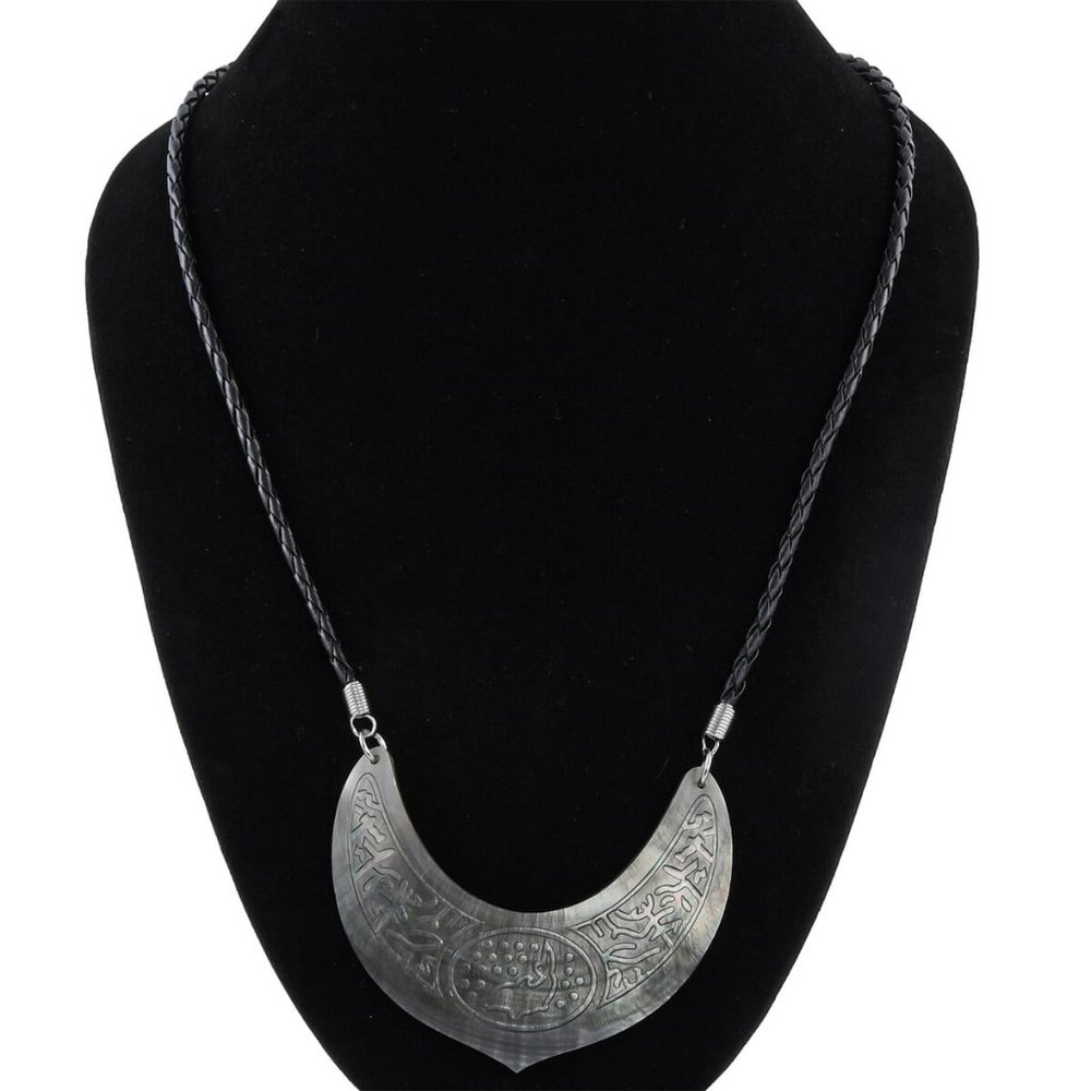 Shell dolphin carving and black suede string
